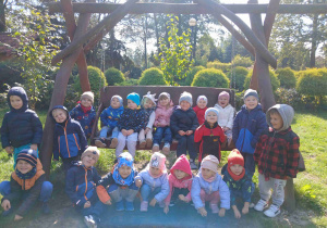 Dzieci pozują przy huśtawce.