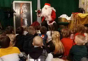 Dzieci słuchają opowieści św. Mikołaja.